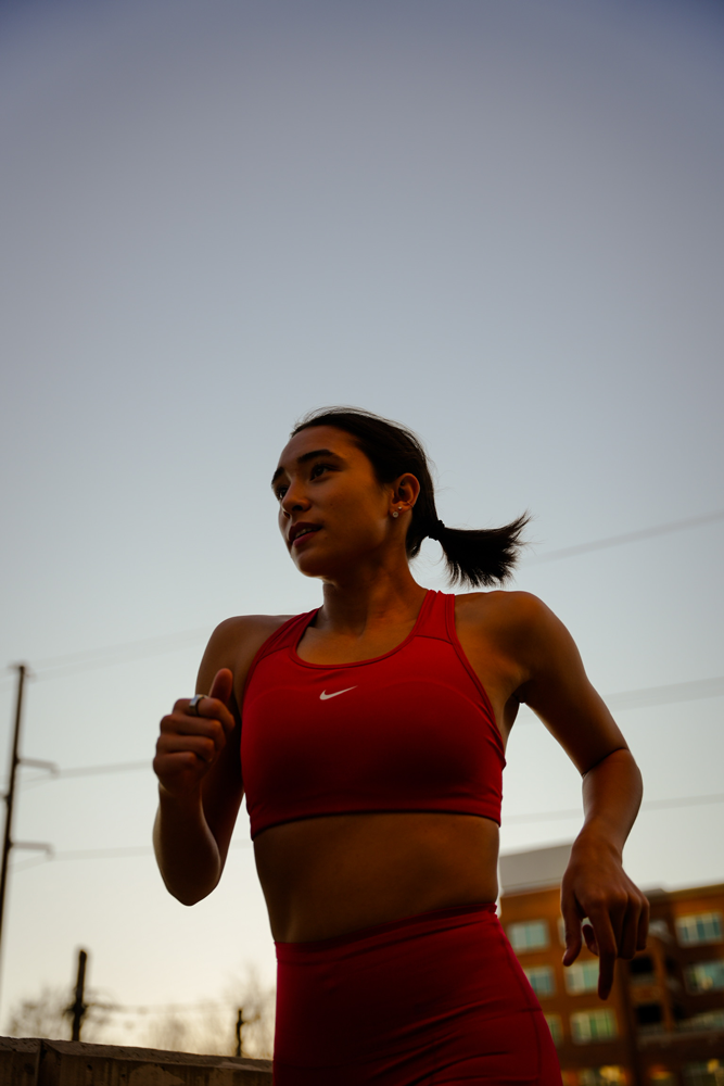 The coach is running while wearing red clothes.